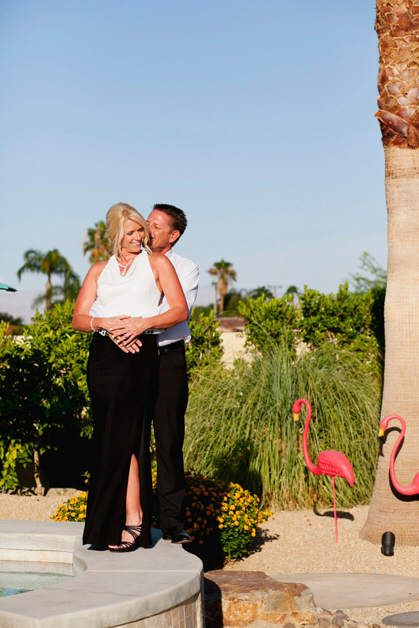 Palm Springs photographer, portrait of bride and groom embracing the full desert sun.