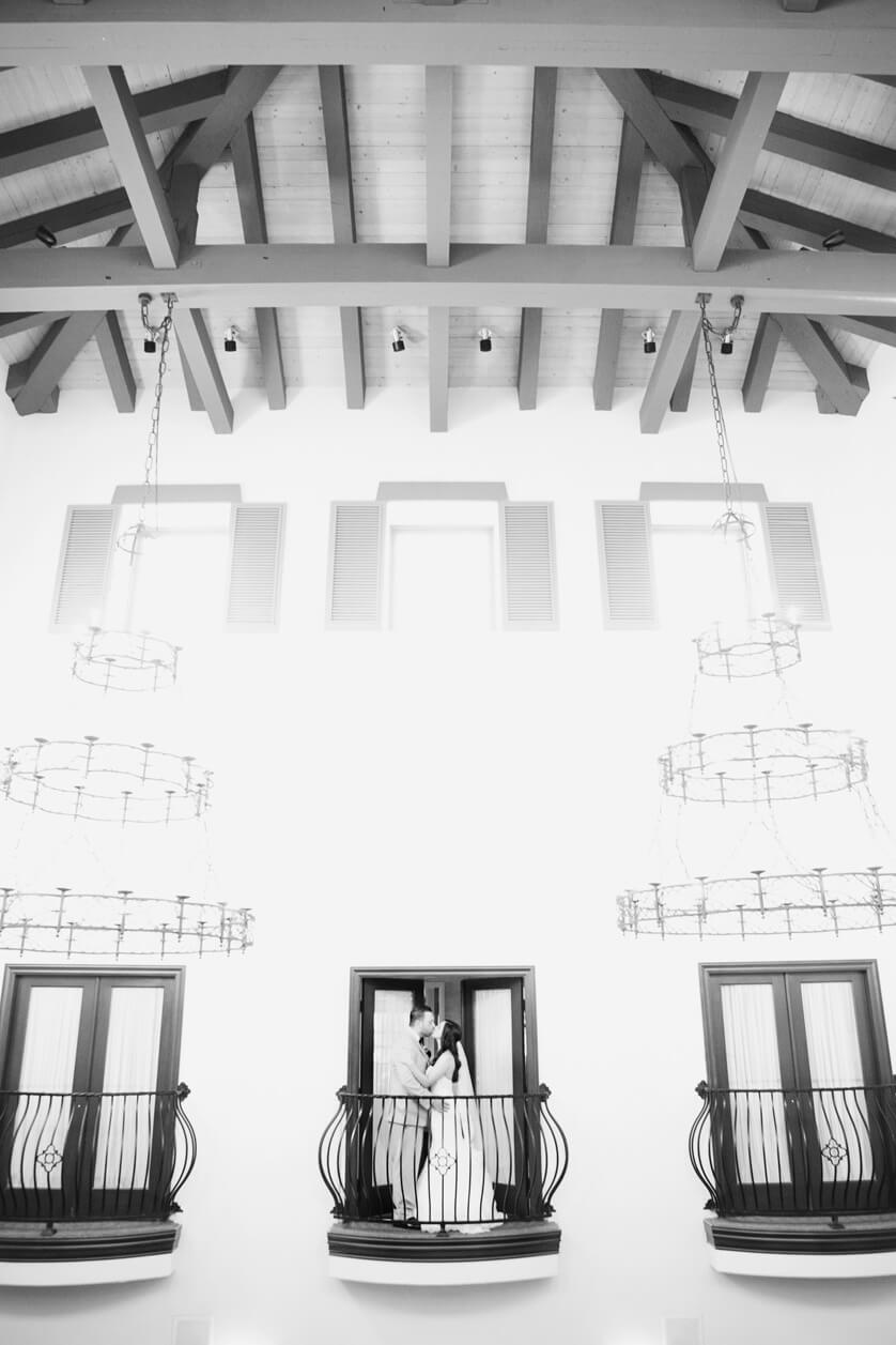 Dramatic balcony portrait of bride and groom 