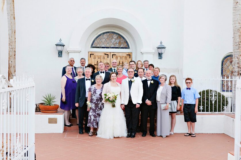 Family poses on the front steps of the church