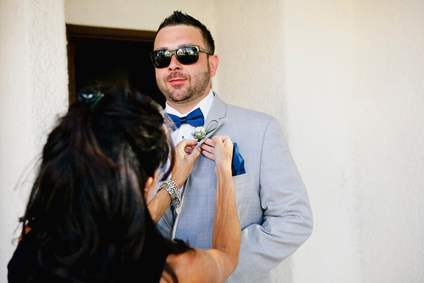 Groom has boutonnière pinned