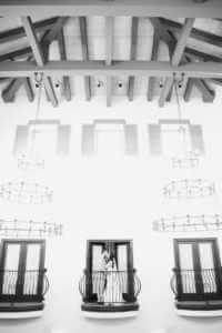 Dramatic balcony portrait of bride and groom