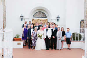 Family poses on the front steps of the church