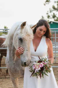 A lovely portrait of the bride with one of her horses