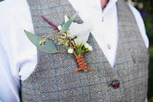 The grooms boutonniere featuring simple flowers