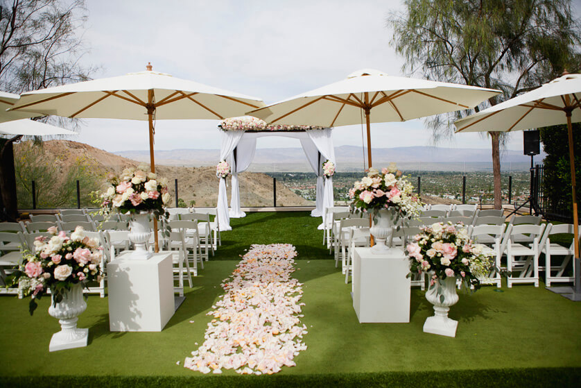 Ceremony site at Ritz Carlton, Rancho Mirage. Rose petals in pinks and white decorate the aisle