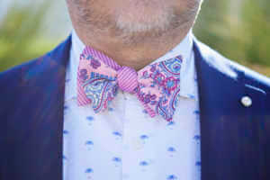 Detail of the grooms fun pink bow tie
