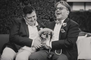 Fun portrait/candid moment with the grooms and their dog
