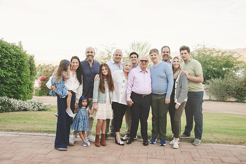 The whole family including three nuclear families and grandma and grandpa pose for a casual photograph at Kempa Villa in Palm Desert