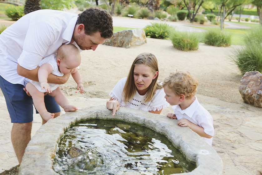 Lovely family moment captured around a pretty park pond
