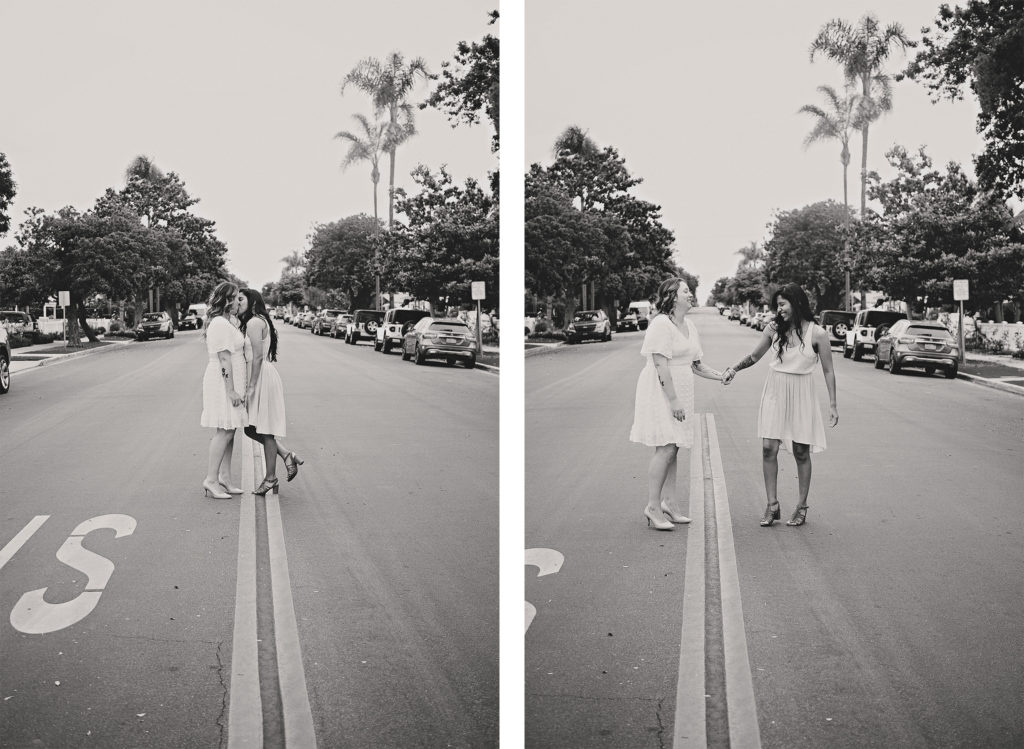 The two brides pose for fun portraits on a quiet neighborhood street.  Using the roads dividing lines as leading the image is creative and symetrical