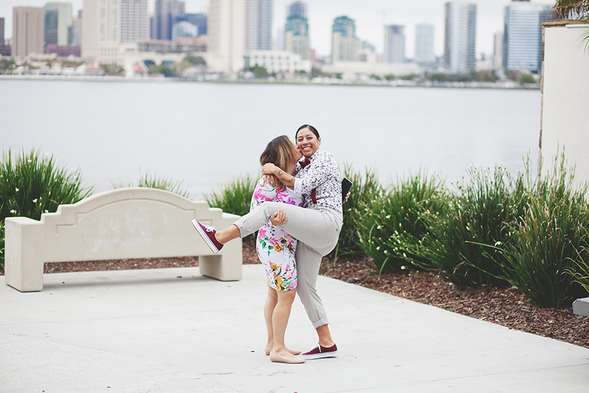 A silly candid of two ladies hugging at a waterfront park on Coronado Island