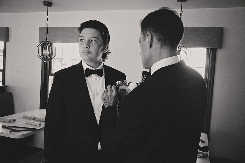 Uncle helps his nephew with the pocket square