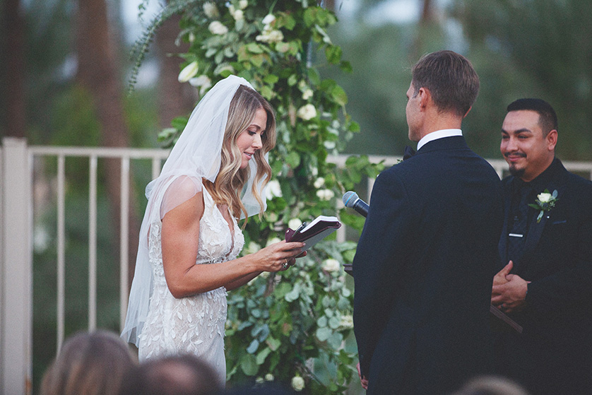 Bride reads her own hand written vows from a pretty notebook