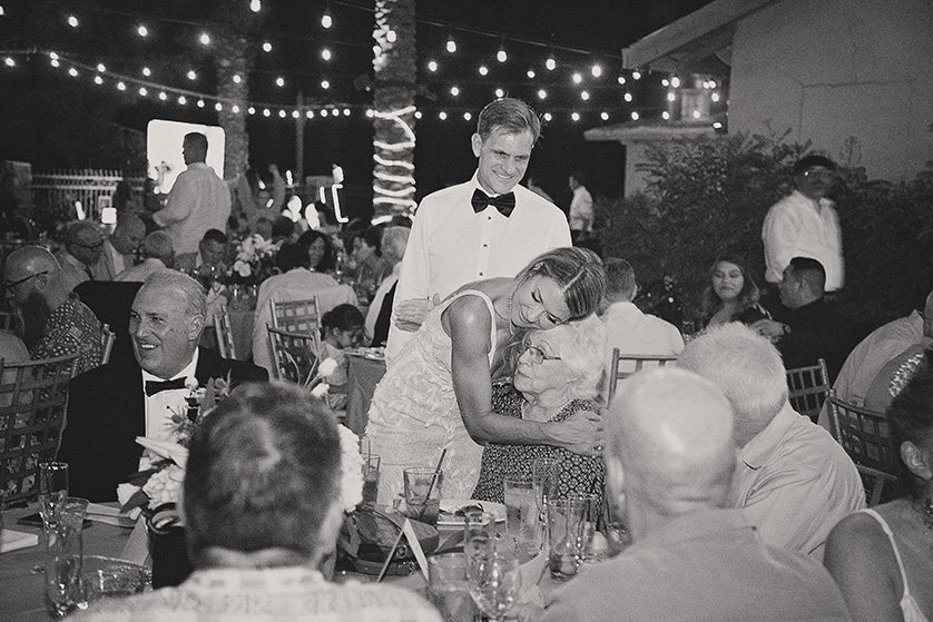 Bride and groom go around to the tables to hug and thank guests