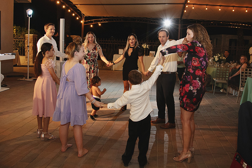 Guests entertain the kids, holding hands and dancing in a circle