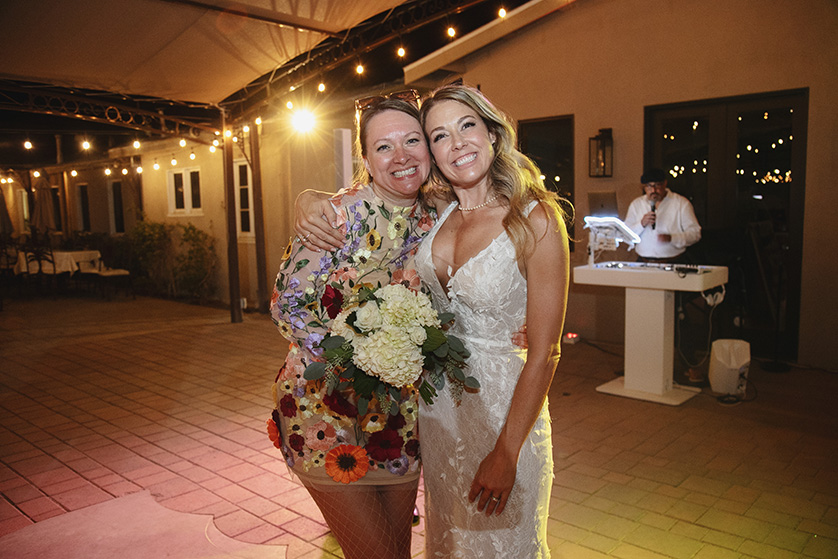 The bride hugs the guest that caught the bouquet