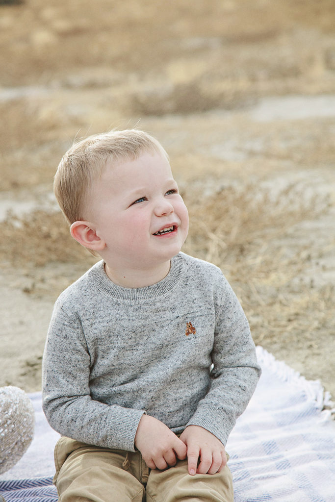 Toddler glances over at his mother with a sweet and loving smile