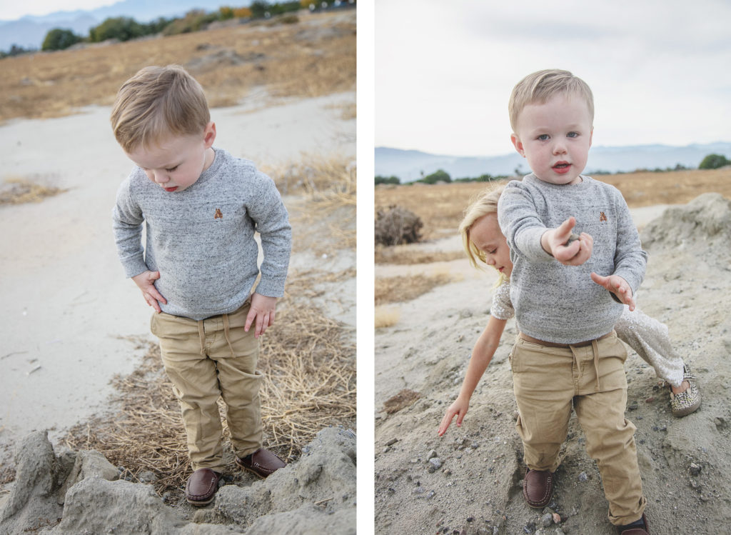 Young boy searching around the desert for a rock