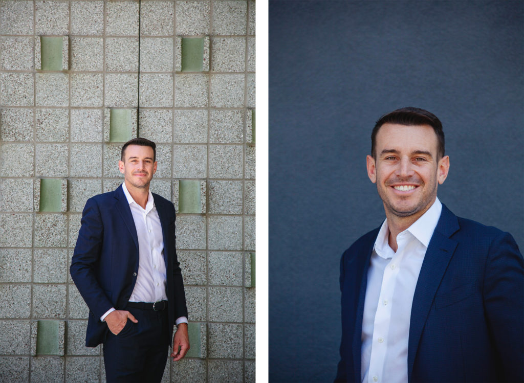 Man in a dark suit and white shirt posing confidently against textured and plain backgrounds.