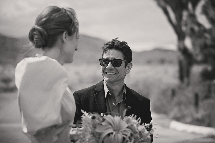 Black and White candid photograph of a bride in joshua Tree along with a guest