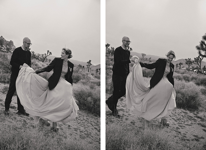 Cute candid captures of the bride and groom walking away, the bride wearing the grooms jacket in the cold windy landscape of Joshua Tree