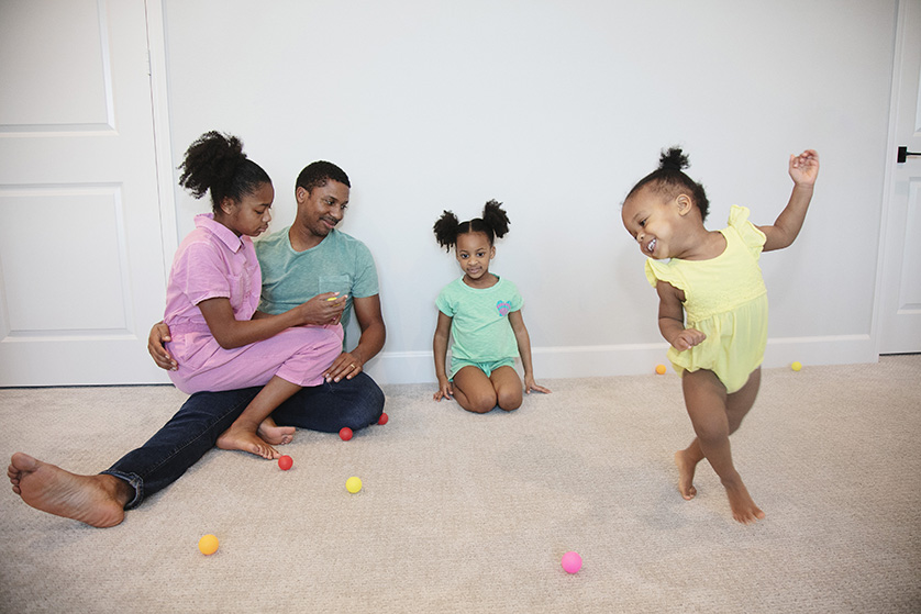 A sweet moment of tenderness and celebration captured, a father and his three daughters