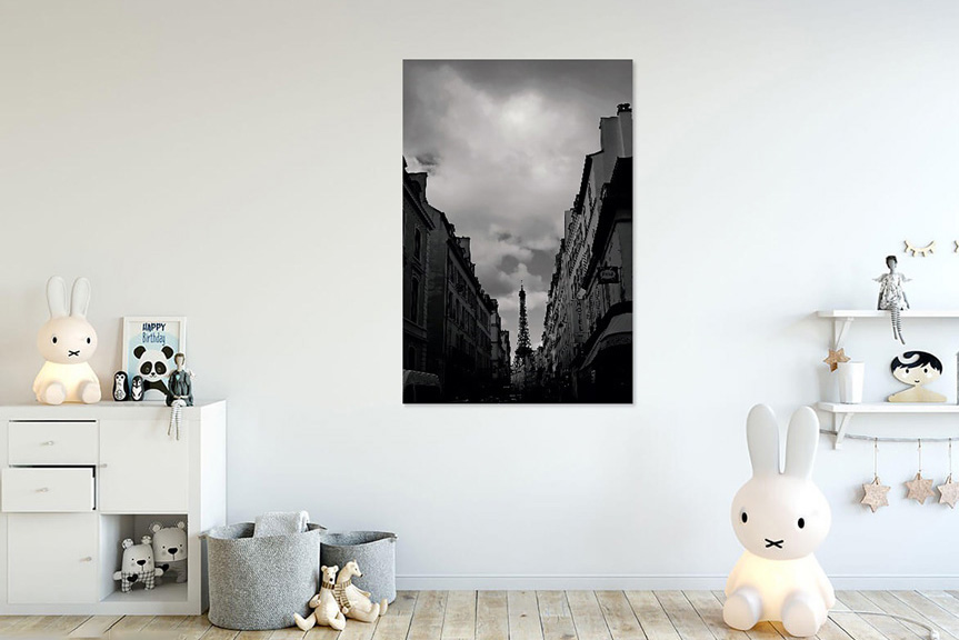 Childs room with toys and photograph of the 
Eiffel Tower in black and white hanging on the wall.