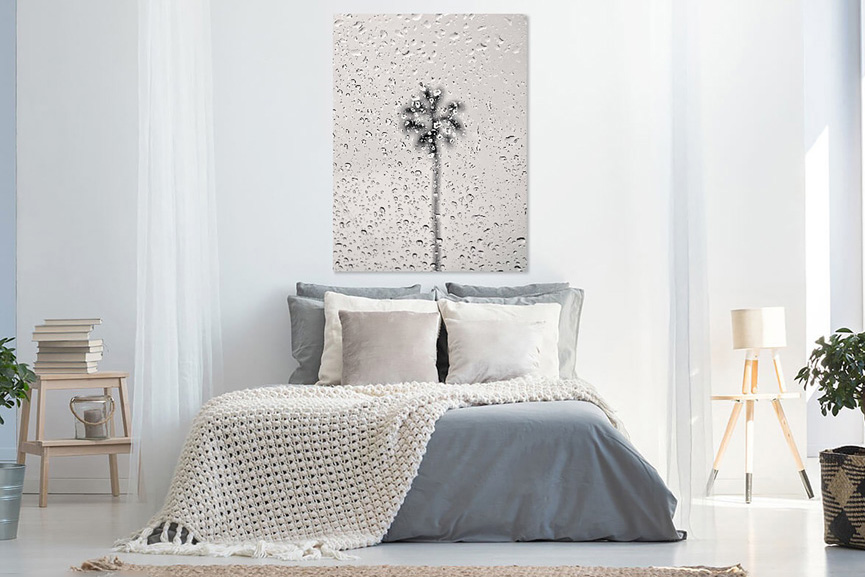 Bedroom in greys and whites with a black and white photograph in the wall