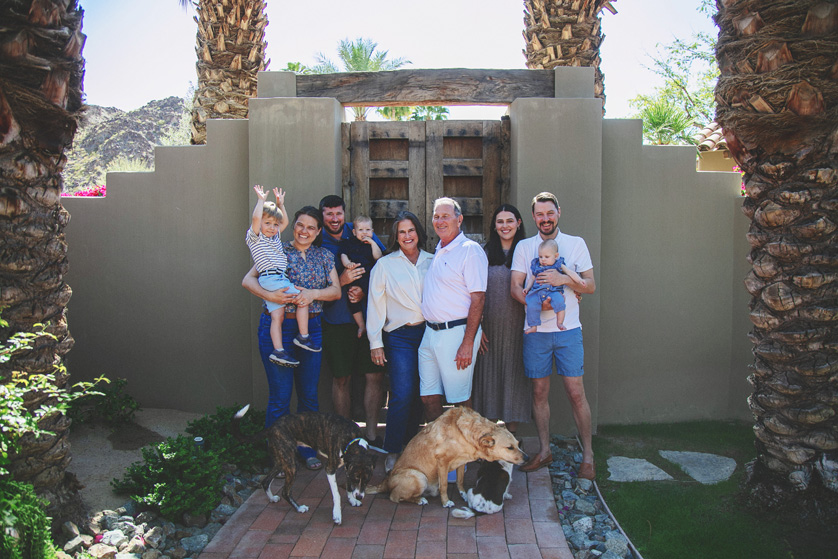 Multi generation family grouping in front of rustic wooden gates