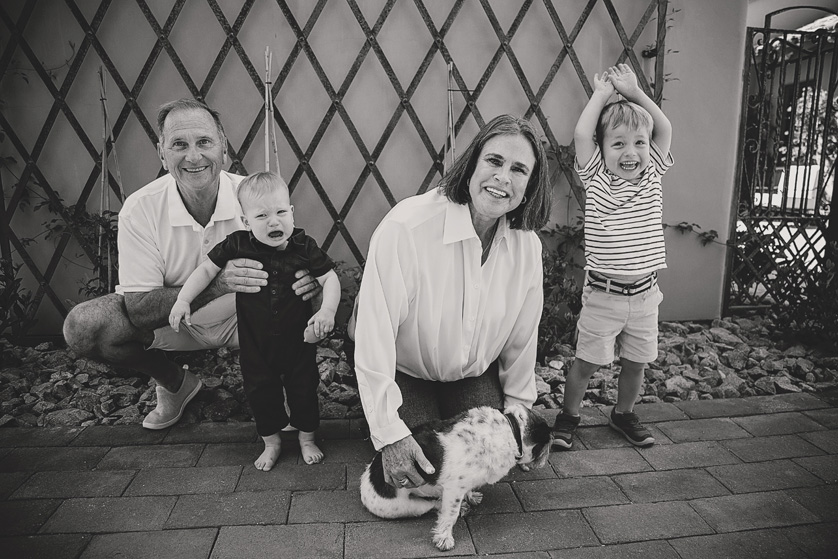 Black and white photo of grandparents with two toddlers and their dog