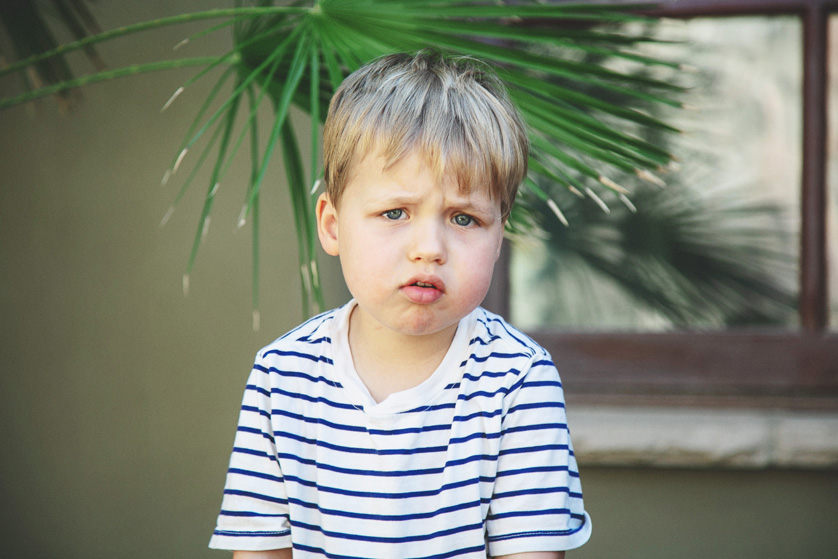 Close up portrait of a toddler looking curiously into the camera