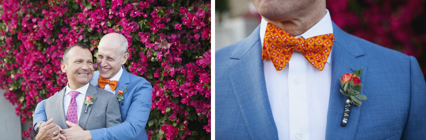 Same-sex grooms pose for photos in front of magenta flowers