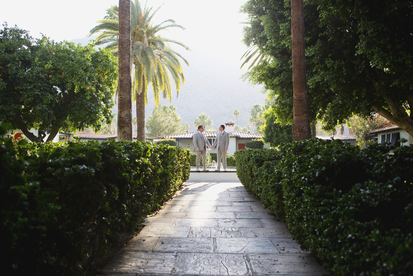 Two grooms in lush greenery