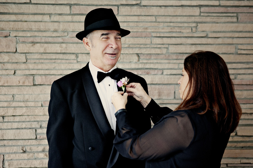 Dapper groom has boutonniere pinned