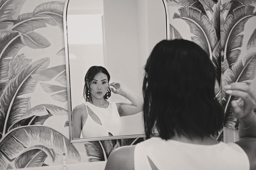 Bride checks her makeup in the mirror