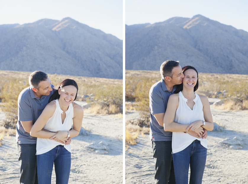 Happy couple embracing outdoors with mountains in the background.