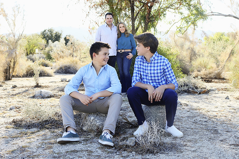 Two boys with mom and dad in desert scenery