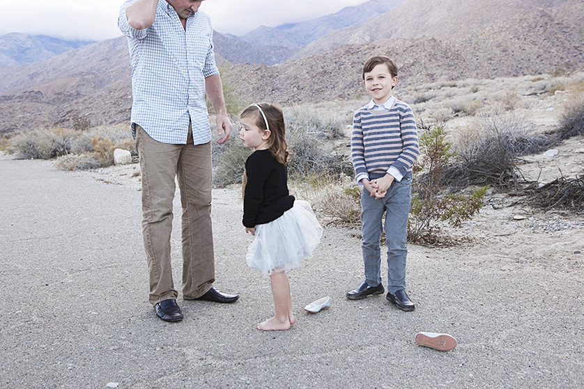 Young girl won't wear her shoes for a family photo