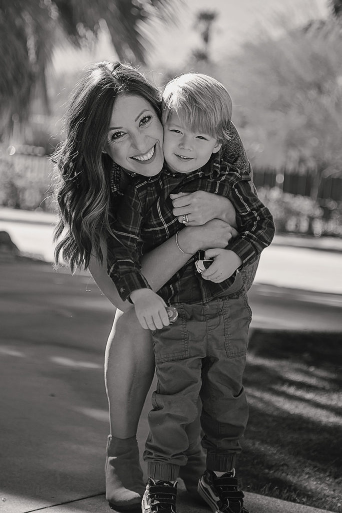 Black and white photo, mom hugs toddler