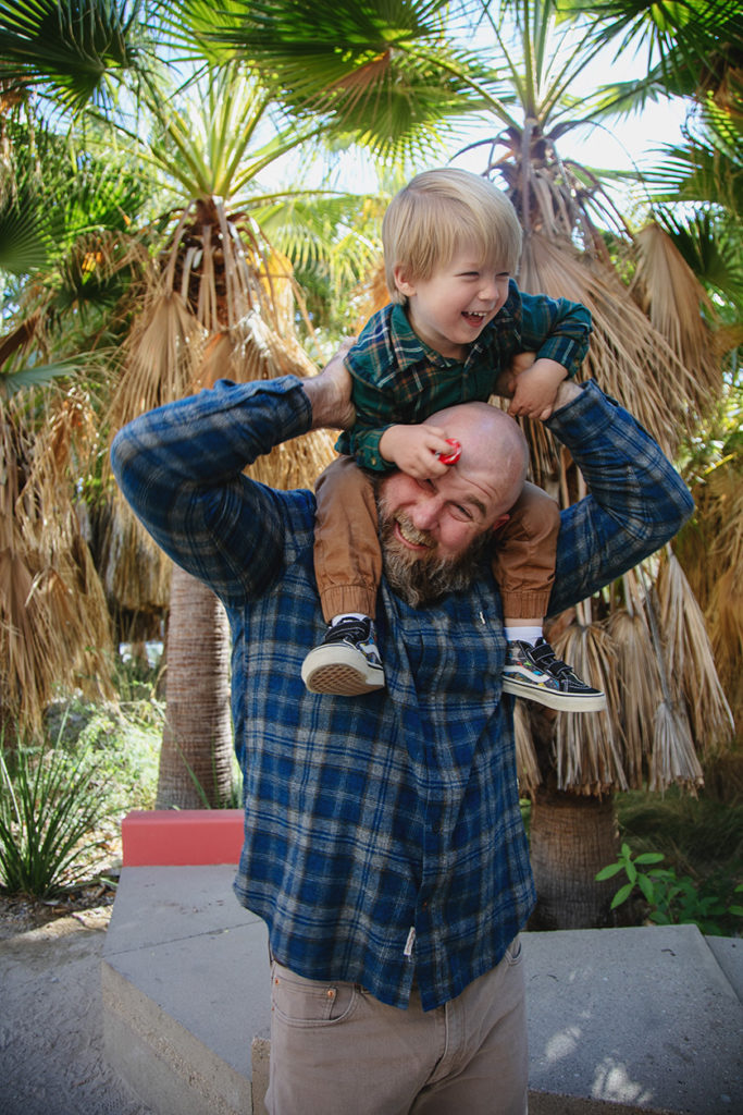 Funny photo of toddler on dads shoulders