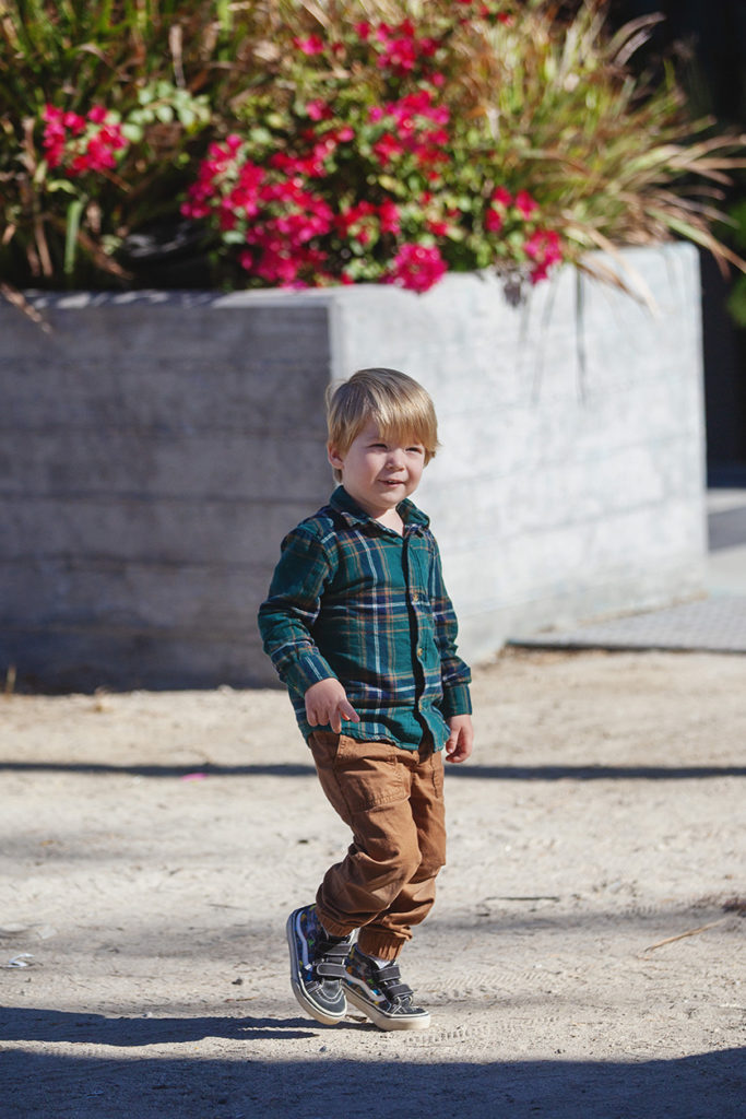 casual toddler strolling in the park