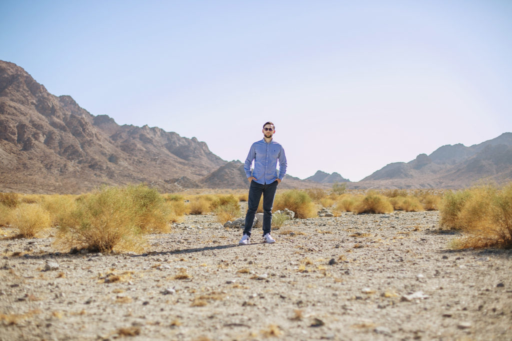 Stark desert landscape with a man standing center frame