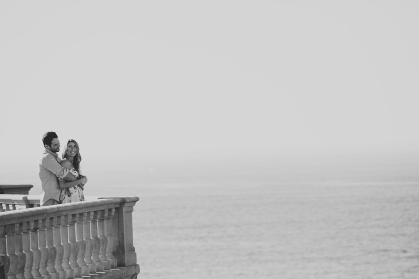 Couple stand on a balcony in black and white