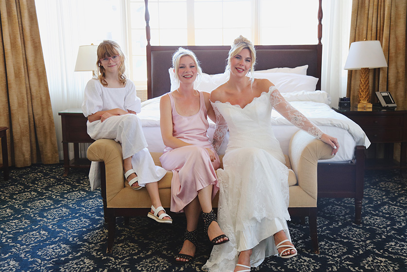 Bride, bridesmaid and little girl pose for photos