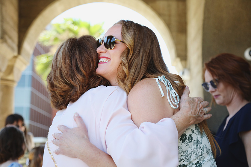 Guests greet each other with hugs