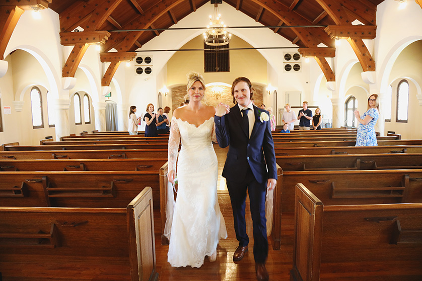 bride and groom come down the aisle after saying I do.