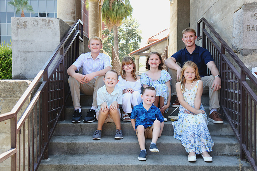 Siblings and cousins all pose of the steps of a church