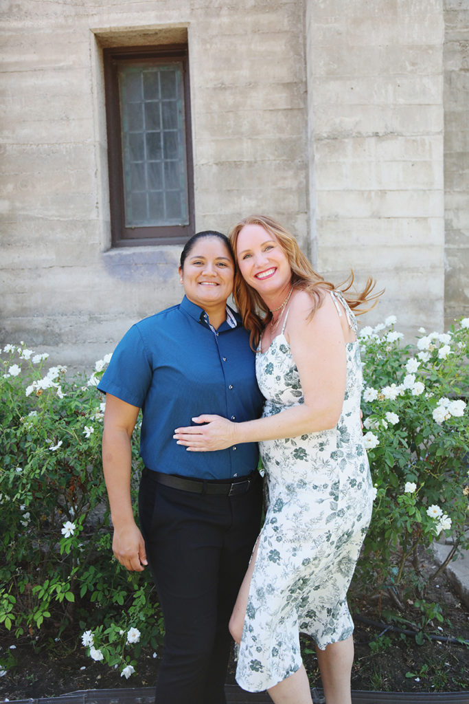 Cute couple pose for a relaxed photo outside a church