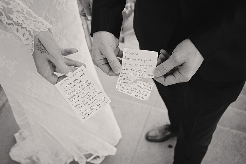 detail photo of the bride and grooms vows written on napkins