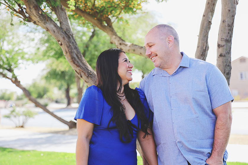 A young couple dressed in blue gaze at each other lovingly